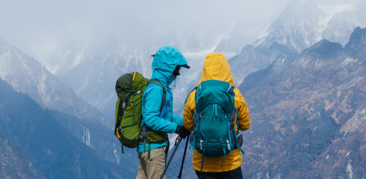 Backpacking woman hiking on high altitude mountain top
