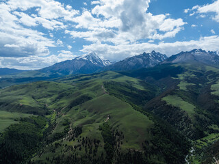Fototapeta premium Aerial view of beautiful high altitude grassland mountains and forest landscape in China