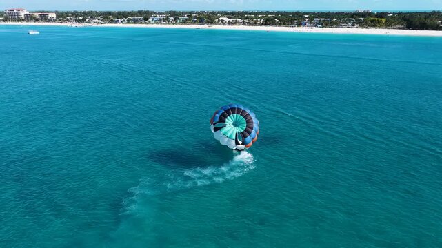 Parasail In Providenciales Overseas Territory Turks And Caicos Islands. Bird Eye View Of Stunning Parasailing Scene Over A Blue Ocean. Paradise Skyline Peaceful Wanderlust.