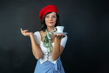Portrait of a beautiful young woman holding a coffee cup. Woman drinking Turkish coffee.