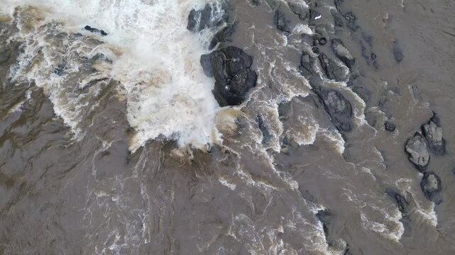 4K Aerial View of Flooded River with Muddy and Turbid Water Flow