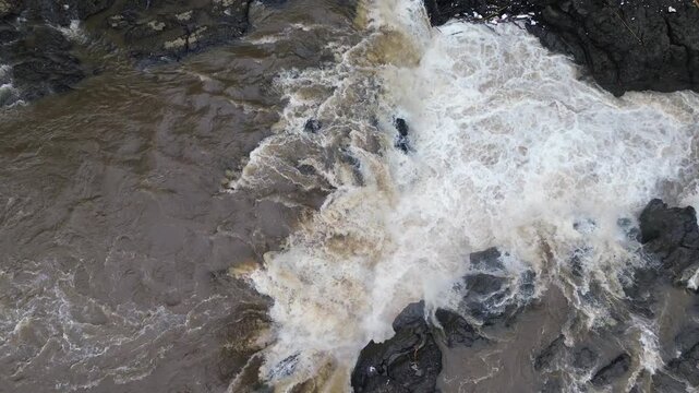 4K Aerial View of Flooded River with Muddy and Turbid Water Flow