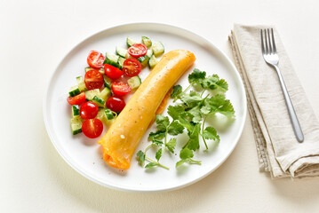 Delicious french omelette with cheese served with fresh vegetabl