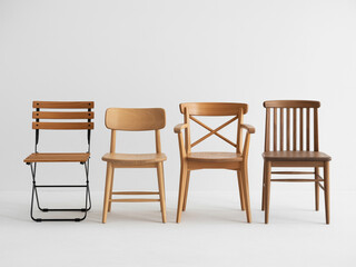Four wooden chairs of different designs arranged in a row