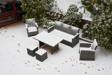 Frosty Backyard Patio With Dormant Furniture, Quiet Snowdusted Patio Furniture Under Chilly Suburban Sky