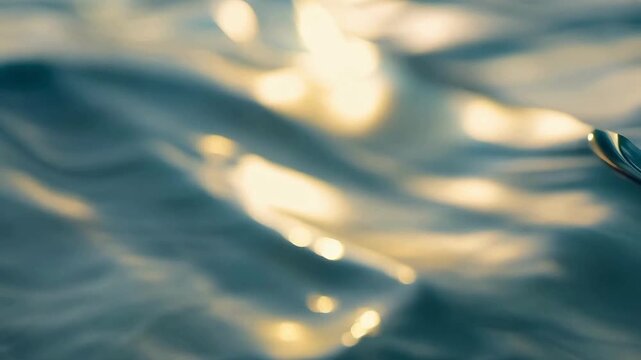 Abstract close-up of ocean waves with sun sparkles and bokeh. Blurry liquid texture with yellow light reflections for summer vibes.