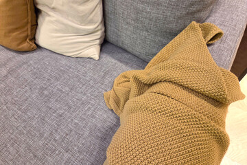 Cozy Sofa Corner with Plush Pillows and Knit Blanket for Home Comfort