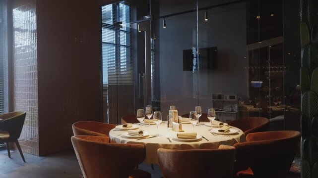 Elegant table with sparkling glassware, Small gathering setup with refined place settings and warm ambiance