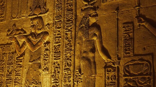 Ancient hieroglyphic carvings on the walls of the temple in Dendera or the temple of Hathor in Egypt. The ancient civilization of the Pharaohs of Egypt.