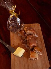 Festive cinnamon rolls with butter and a gift bag