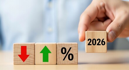Hand placing 2026 block with growth and decline percentage symbols