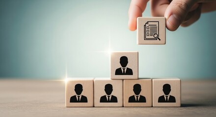 Hand placing analytics icon block on team hierarchy management concept