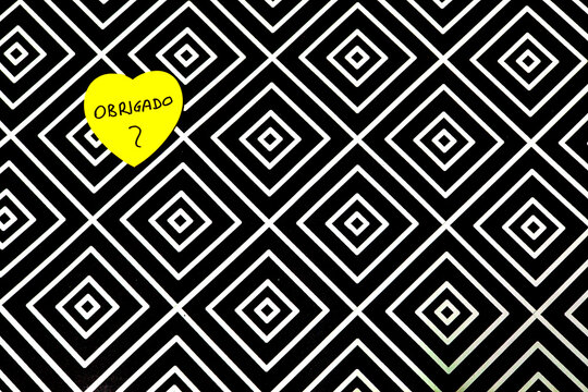 A black and white patterned background with a yellow heart - Powered by Adobe