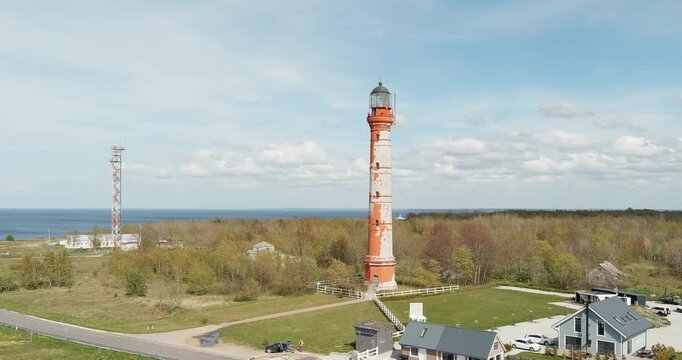 Aerial view of Pakri lighthouse, located on the Pakri peninsula, in sunny spring weather with clouds in the sky, Estonia.