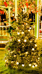 View on the illuminated top of a shiny christmas tree