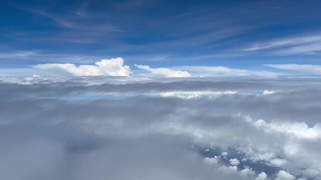 Aerial View of Cloudy Sky from Airplane Window