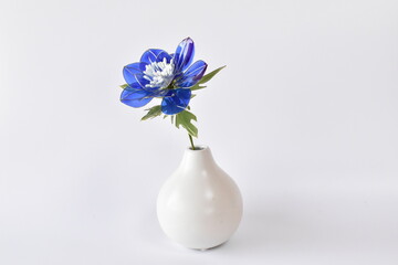 Blue dip art anemone flower with transparent petals, handmade botanical still life on white background