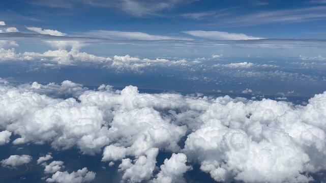 Aerial View of Cloudy Sky from Airplane Window