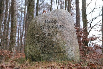 Memorial stone with the inscription "Border Road" and the year 2012 and the logo of the Gdansk Forest District in Tricity Landscape Park, Pomerania, Kashubia, Poland