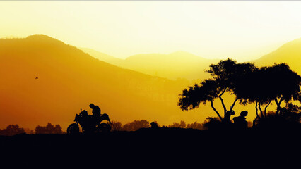 Mountain And Trees And Motorcycle Silhouette At Golden Sunset