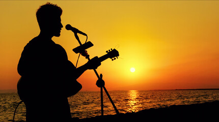 Street Musician Playing Guitar At Sunset