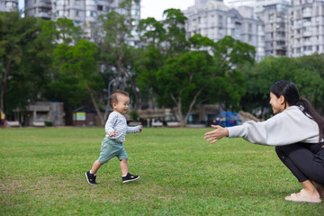 Fototapeta premium Mother opening arms waiting baby hug at park