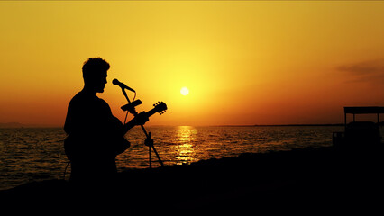 Guitar Player Silhouette Performing At Sunset