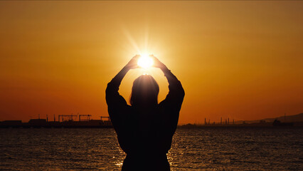Hands Framing The Sun At Golden Hour at Sunset