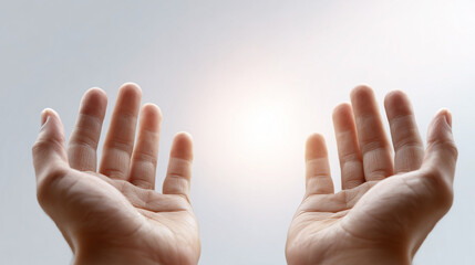 Two hands are raised in the air