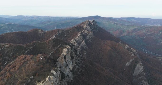 Aerial view of the rugged Dolomiti Lucane mountains with its distinctive grey rock formations and autumnal foliage, Castelmezzano, Basilicata, Italy.