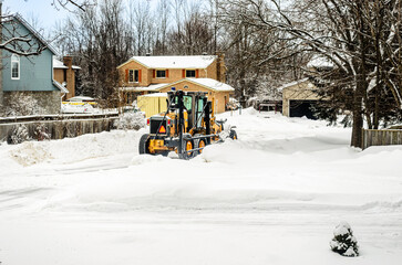 Motor Grader snowplow clearing residential streets