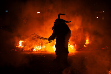 Krampus in the midst of flames is a demonic being that accompanies the religious folkloric figure. This tradition is linked to Christian mythology.