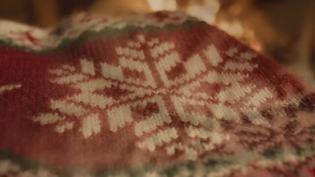 Close up of decorative knitted pattern with reindeer designs