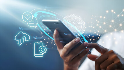 Close up of a person using a smartphone with digital icons floating around it