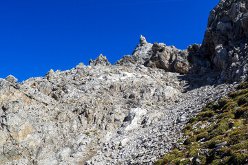Fototapeta premium Wild Lechtal Alps with rugged peaks and a tranquil alpine mountain lake.
