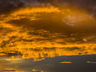 Beautiful sky view at sunset or sunrise with orange clouds and blue sky background. Sky landscape at dusk.