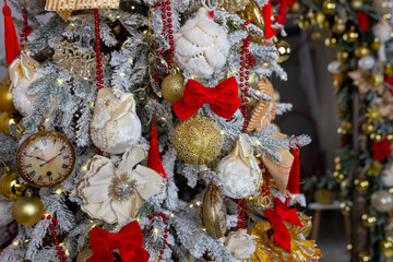 an elegant Christmas tree decorated with large balls in a red and gold color scheme using large fabric velvet bows and glass products. interior of a residential house or a children's room