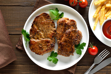 Homemade juicy grilled pork steaks on plate