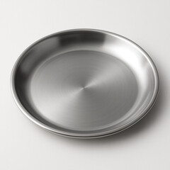 A single empty round stainless steel plate isolated on a white background as a clean blank kitchen utensil and dishware object for serving a meal in a restaurant or home dining table