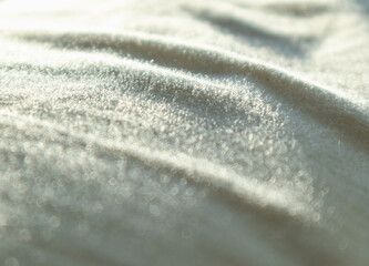 Close up of the pattern of morning sunlight reflected on interior textile