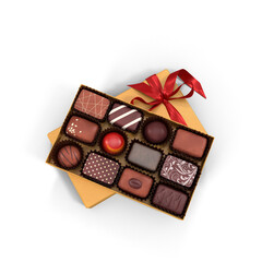 Luxury chocolate gift box with assorted pralines and heart shaped candies inside open black packaging with red ribbon bow creating elegant romantic concept for valentine and celebration designs