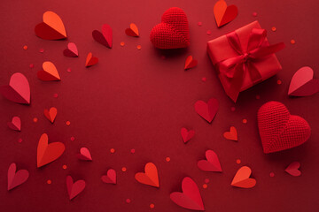 Valentine day romantic frame background with red hearts and gift box top view.