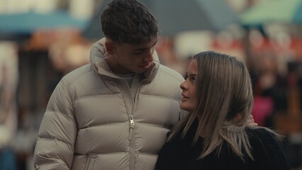 A romantic young couple in Paris France are looking at each other with love and affection on a city...
