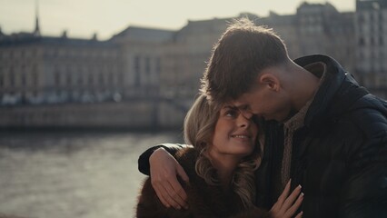 A romantic couple embraces in Paris France with a cityscape backdrop showcasing love and affection. This image is suitable for travel photography European vacation themes and relationship goals conten