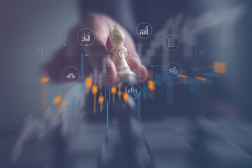 Business leader moving a chess piece above digital candlestick charts and interface icons, symbolizing strategy, financial planning, data analytics, investing, growth, and innovation