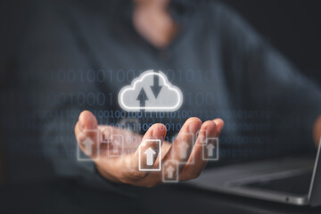 Hand holding cloud upload icon over binary code and digital interface, symbolizing cloud computing, data storage, cybersecurity, backup, file transfer, and modern IT infrastructure