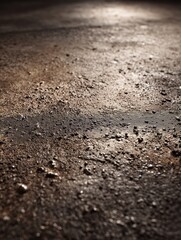 Close-up of textured wet ground with sparkling reflections in low light