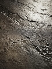 Close-up of textured wet surface with dramatic lighting showcasing reflective patterns