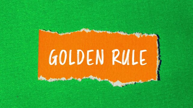 Golden rule message writing on ripped torn paper background
