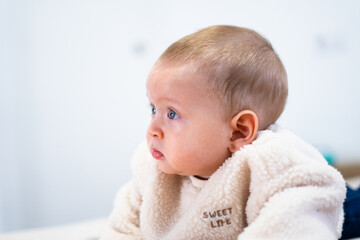 Adorable baby staring with curious expression © Arianne